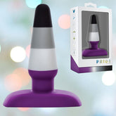 The Avant Pride P7 - Ace, an exquisite plug toy by Avant, is made from body-safe silicone and features elegant horizontal stripes in purple, white, and black. It arrives with its packaging and includes a flared base to ensure safety. The softly blurred bokeh background enhances the product's appearance with circular lights in diverse colors.